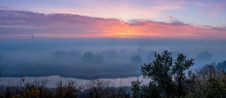 panorama of sunrise over the river and fogの写真素材