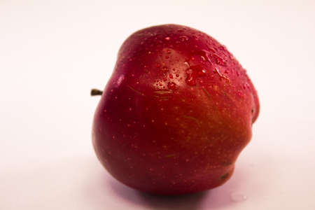 red apple with water drops on white background