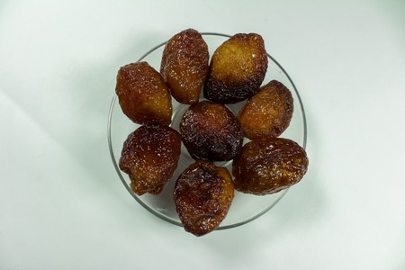sun dried apricots with seed isolated on whiteの写真素材