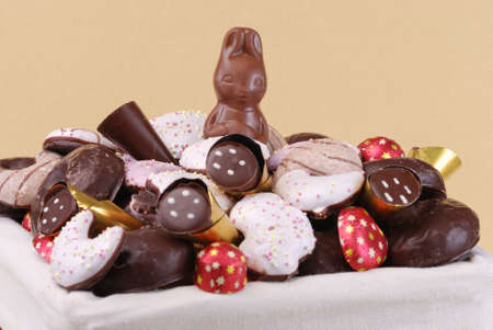Easter basket with sweets on golden backgrond