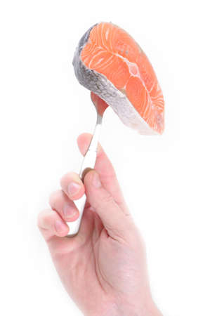 raw salmon steak on forkの写真素材