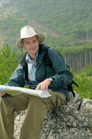 Hiker looking at a map while out trekking