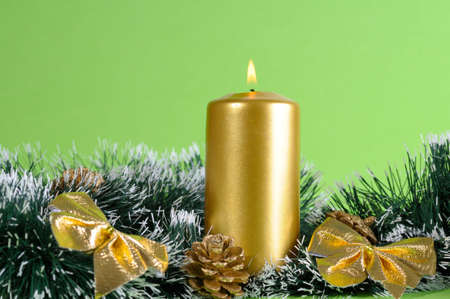 Christmas arrangement of candle, ribbons and decorationsの写真素材