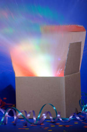 opened cardboard box package with glowing lightの写真素材