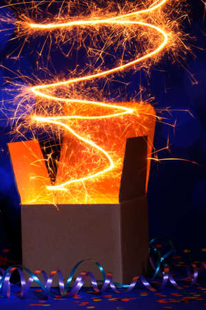 opened cardboard box package with glowing lightの写真素材