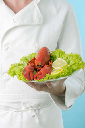 Chef with lobster plated with lemonの写真素材