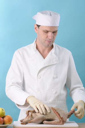Chef cooking goose with applesの写真素材