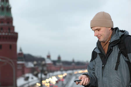 Man with phone against Kremlin, Moscowの写真素材