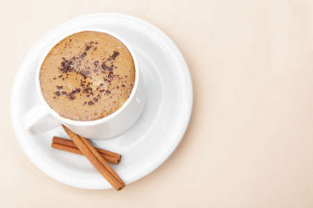 Cup of coffee and a couple of cinnamon sticksの写真素材