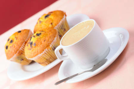 Cup of coffee and three muffinsの写真素材