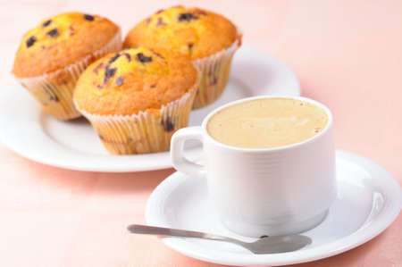 Cup of coffee and three muffinsの写真素材