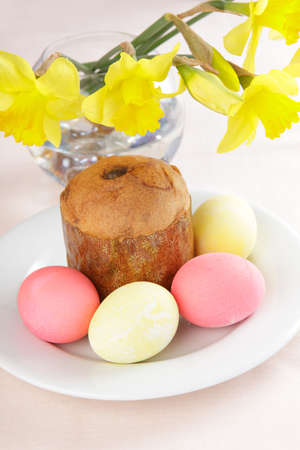 Russian Easter cake and eggs on white plate