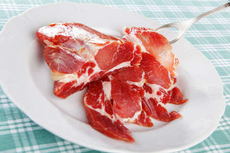 Ham on white plateの写真素材