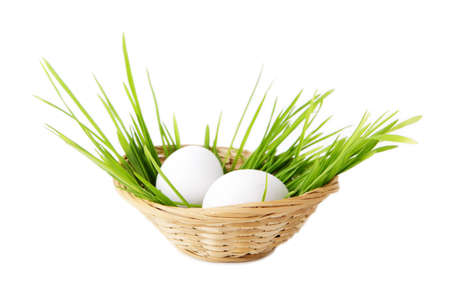 Chicken eggs in basket isolated on white