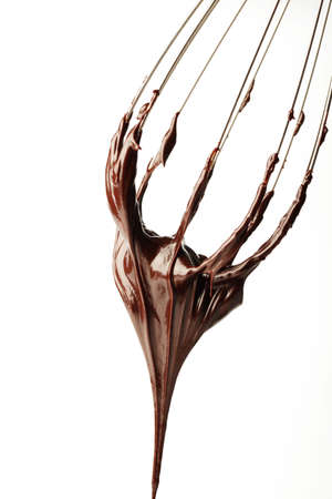 Whisk with liquid chocolateの写真素材