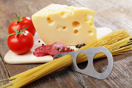 Piece of yellow cheese and sliced salami