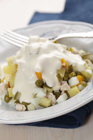 Russian salad in white plate closeupの写真素材