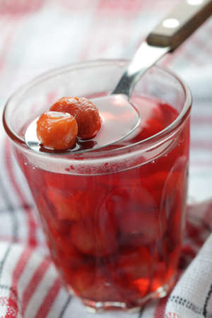 Sour cherry compote in the rustic glass closeup