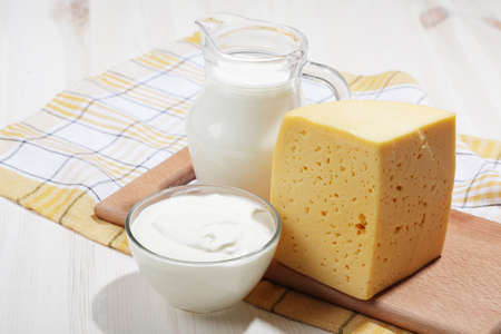 Milk, sour cream, and a segment of cheeseの写真素材