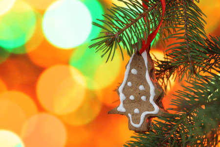 Christmas cookies on the Christmas tree against Christmas lights