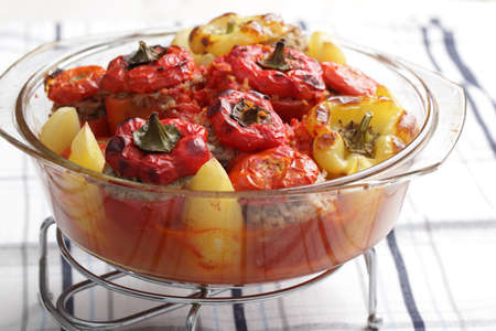 Stuffed tomatoes and peppers in the glass casseroleの写真素材