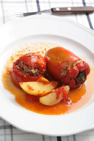 Stuffed pepper and tomato with baked potatoの写真素材
