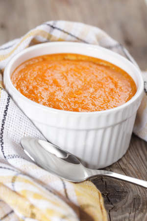 Just baked pumpkin souffle in white bowl closeup