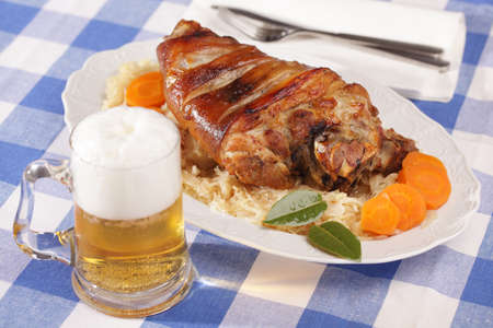 Eisbein, roasted pork knuckle with braised cabbage and beerの写真素材