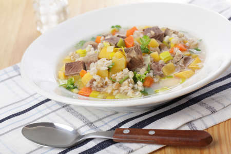 Scotch broth soup in white plate closeupの写真素材