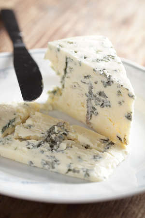 Segment of blue cheese on the white plateの写真素材