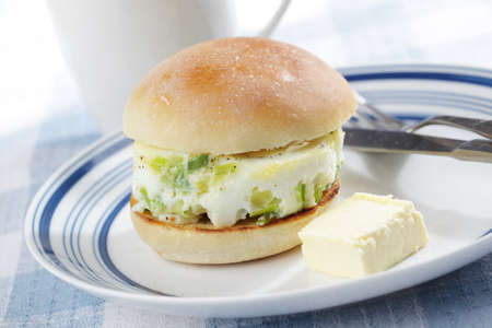 Breakfast with baked eggs on the toasted bunの写真素材