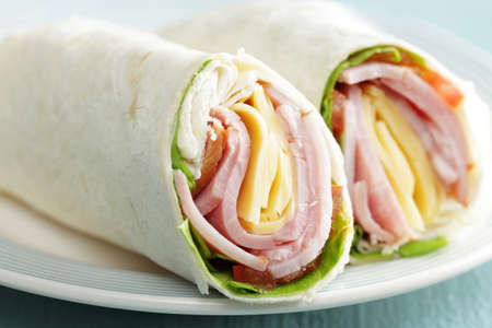 Tortilla roll-ups with ham, cheese, and vegetablesの写真素材