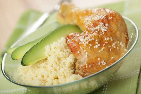 Roasted chicken leg with couscous and avocadoの写真素材