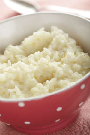 Rice pudding in the red bowl closeupの写真素材