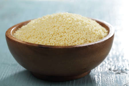 Raw couscous in the wooden bowlの写真素材