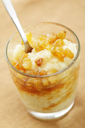 Rice pudding with raisins and cinnamon syrupの写真素材