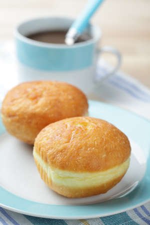 Donuts on the plate and the cup with hot chocolate