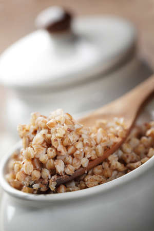 Buckwheat cereal in the wooden spoon closeupの写真素材