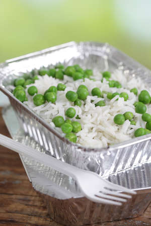 Basmati rice with green peas in the disposable aluminum panの写真素材