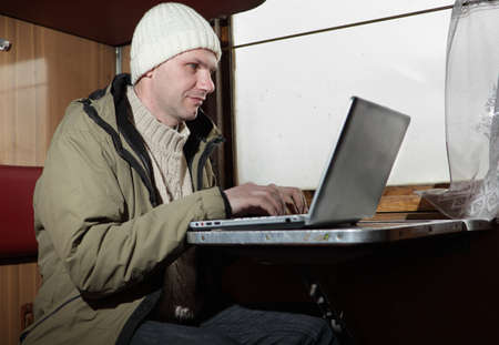 Man working with laptop in the trainの写真素材