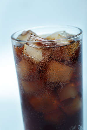 Glass of cola with ice closeup