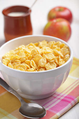 Breakfast with cornflakes, yogurt, and apples