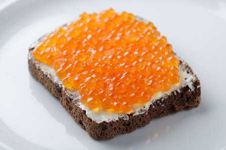 Open sandwich with red caviar on the rye bread. Shallow DOFの写真素材