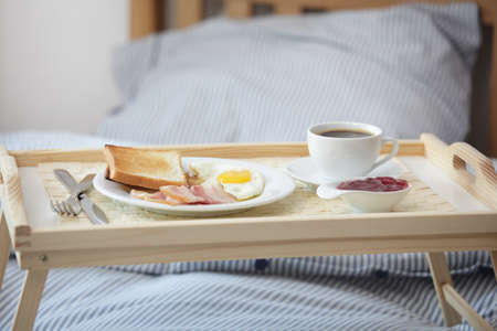 Tray with breakfast on the bedの写真素材