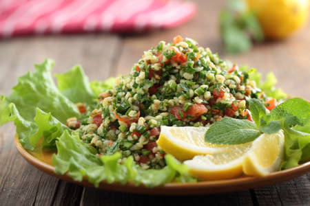 Tabbouleh salad closeup on a rustic tableの写真素材