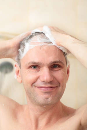 Man washing his hair with shampoo