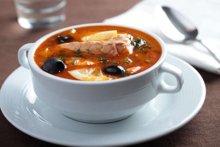 Solyanka, Russian soup with salmon, olives and lemonの写真素材
