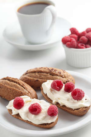 Sandwiches with rye bread, soft cheese, and raspberry