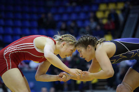Kiev, Ukraine - February 16, 2013: Match between Helen Maroulis, USA, blue and Katsiaryna Hanchar, Belarus during XIX International freestyle wrestling and female wrestling tournament in Kiev, Ukraine on February 16, 2013のeditorial素材