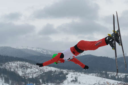 Bukovel, Ukraine - February 23, 2013: Chao Wu, China performs aerial skiing during Freestyle Ski in Bukovel, Ukraine on February 23, 2013.のeditorial素材